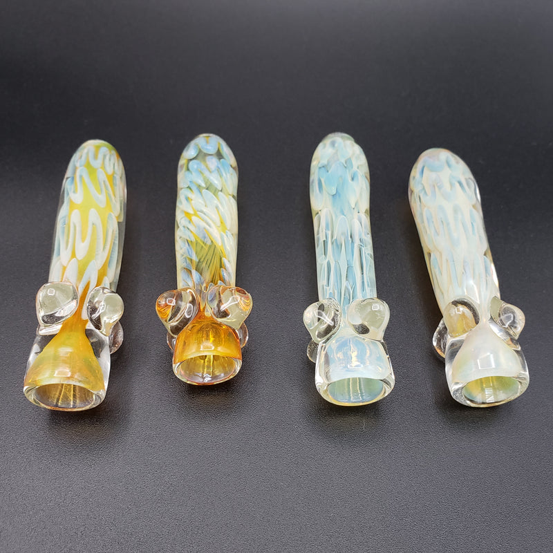 Two Gold Heavy Glass Chillum and Two silver heavy glass chillums on a light grey backgorund