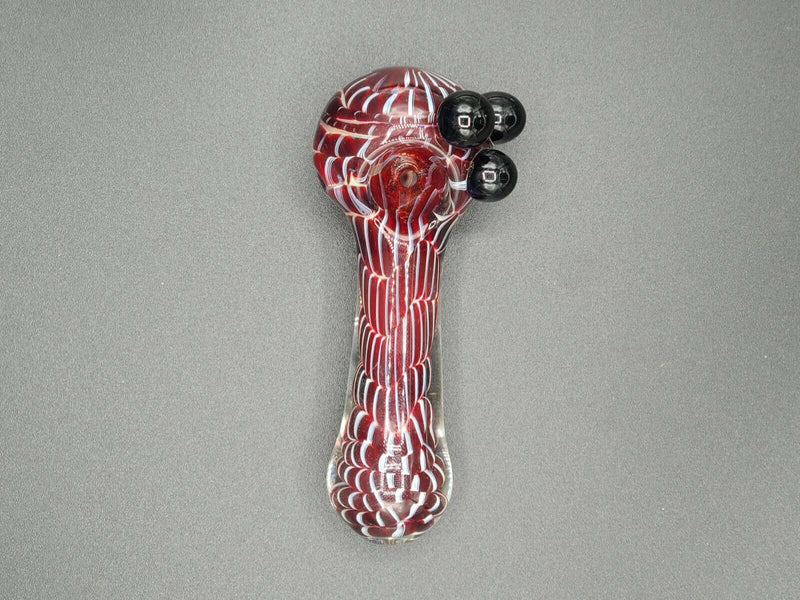 A red Glass Bowl Spoon Pipe on a grey background