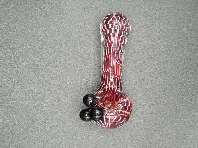 A red Glass Bowl Spoon Pipe on a grey background