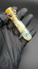 A presentation video of a gold heavy glass chillum
